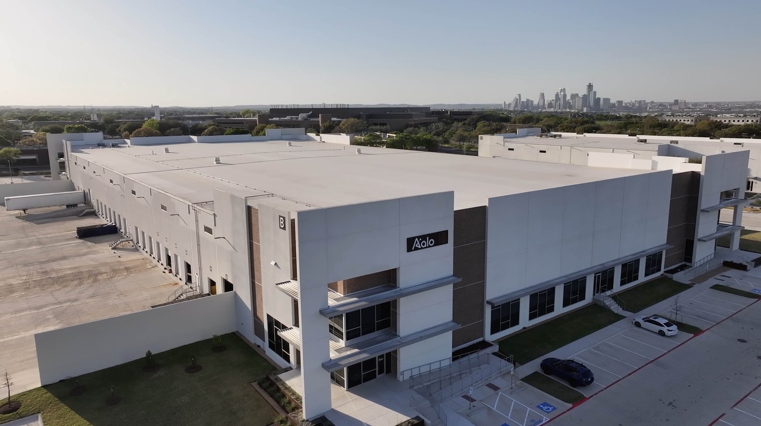 Aalo Atomics' facility at the Crosspoint industrial park, with the Austin skyline in the distance