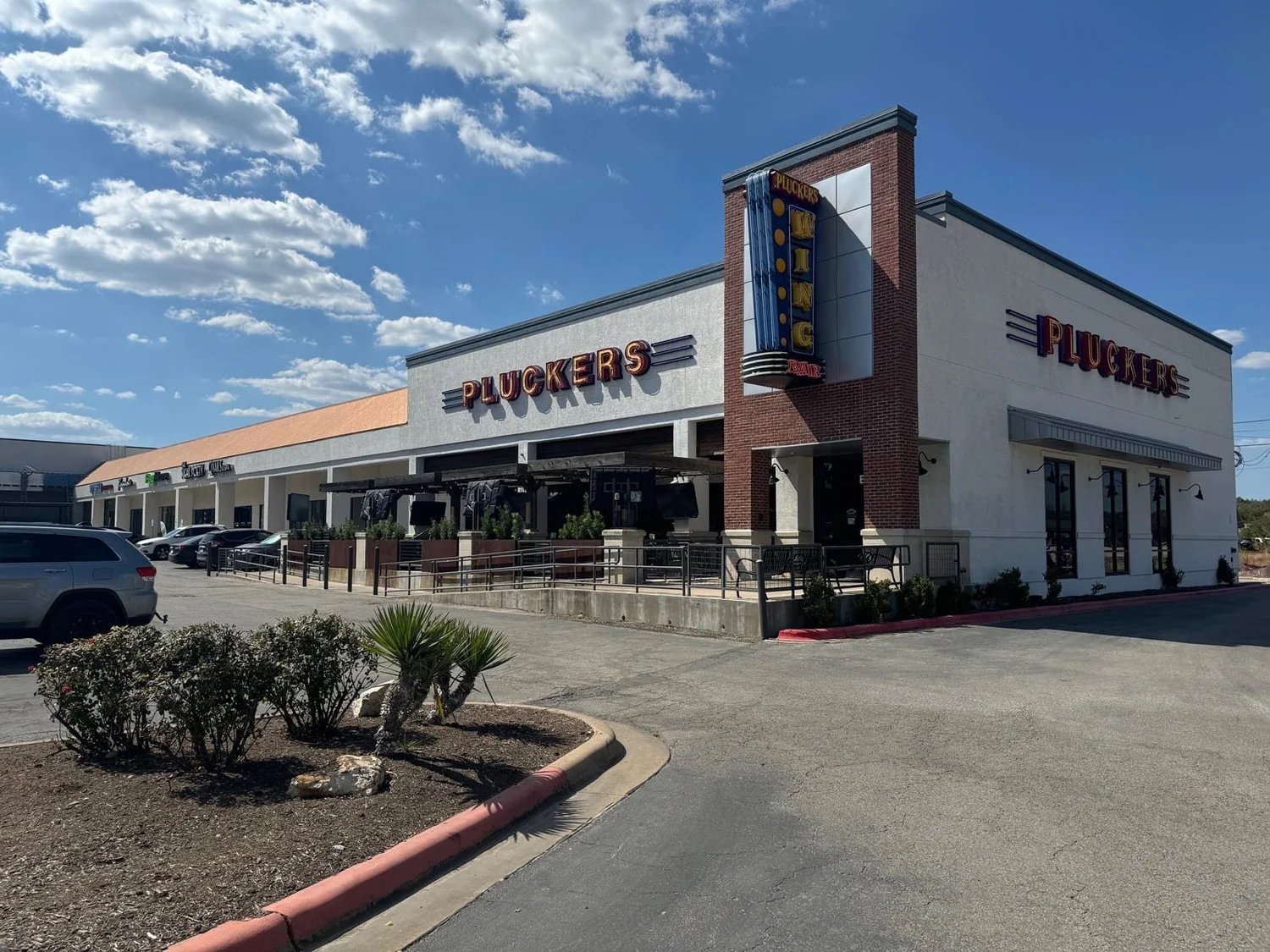 Oak Hill Plaza's renovated storefronts, including anchor tenant Pluckers