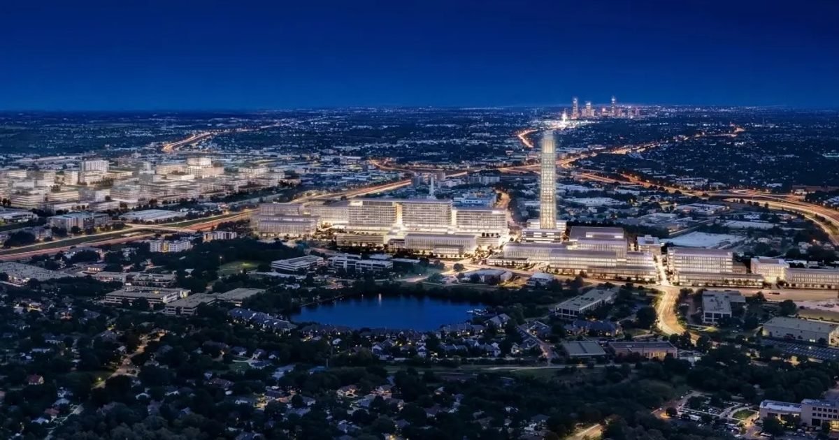 Aerial night rendering of the UT Dell Medical Center campus with downtown Austin in the distance