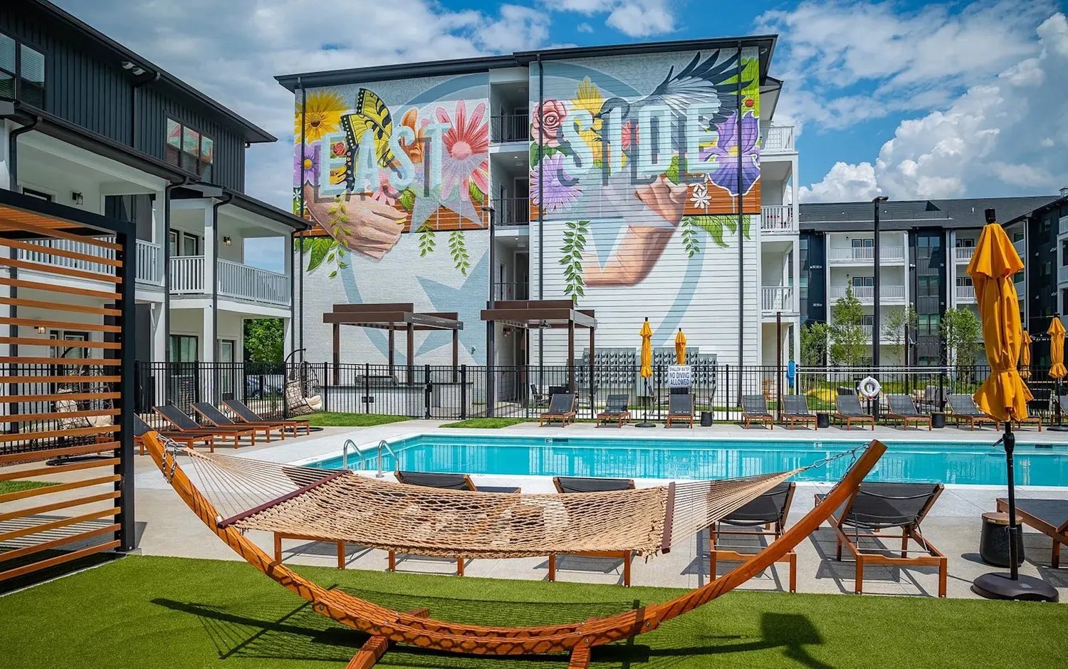 Pool courtyard at The Flats at Laurel & Pine, featuring the 'East Side' mural