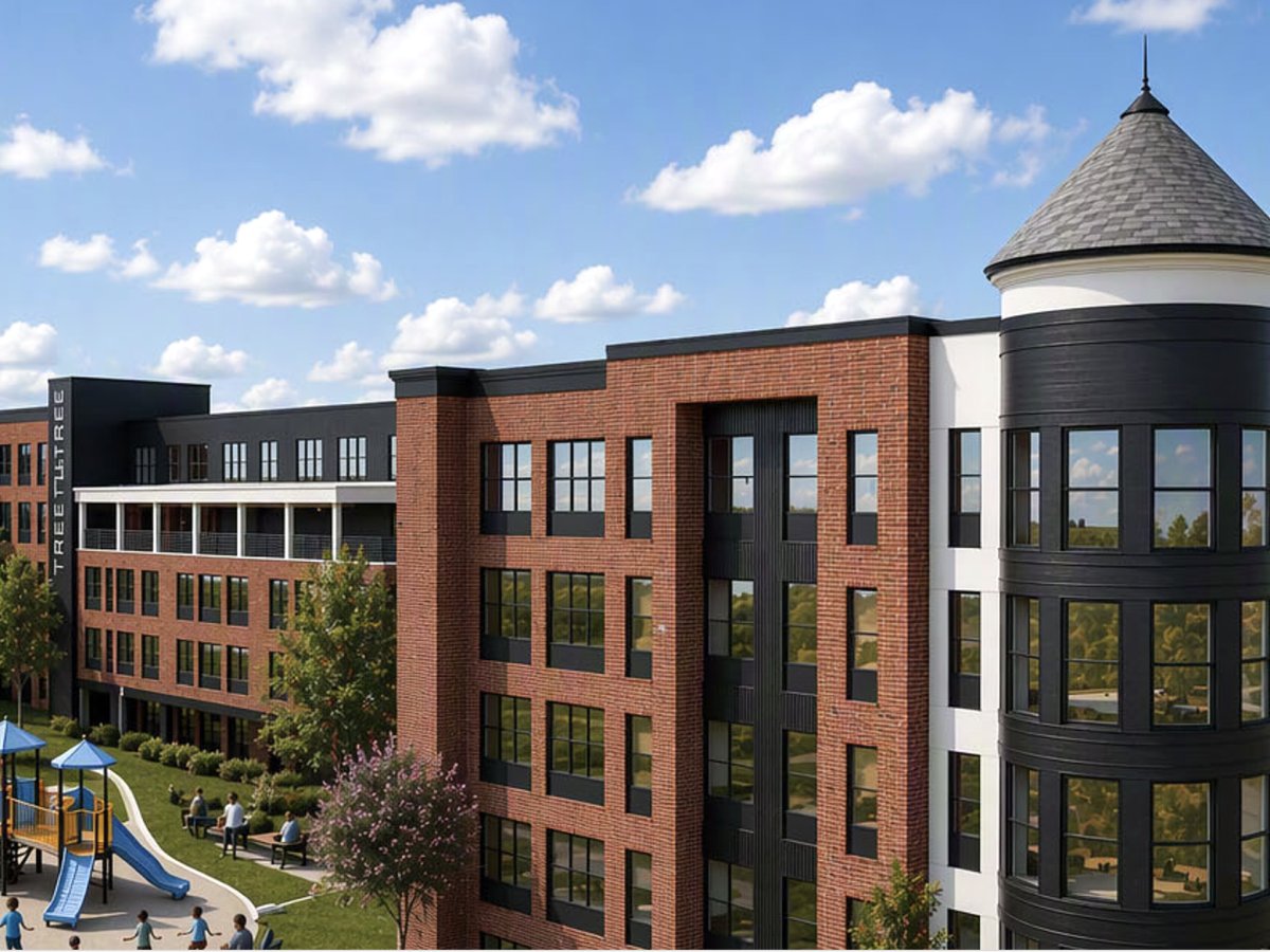 Close-up rendering of a Trestletree Village residential building with signature turret and playground