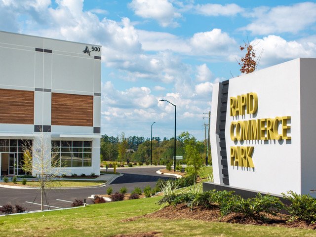 Rapid Commerce Park monument sign with the AXIAL building at 500 Rhyne Rd