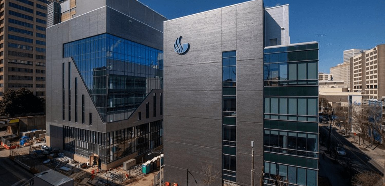 The GSU Research Tower nearing completion, with the university's flame logo mounted on the facade