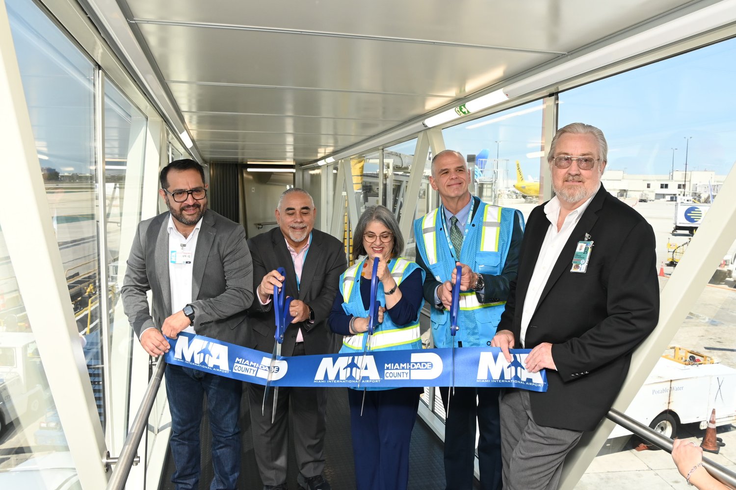Miami-Dade officials cut the ribbon on the newest glass passenger boarding bridge at MIA