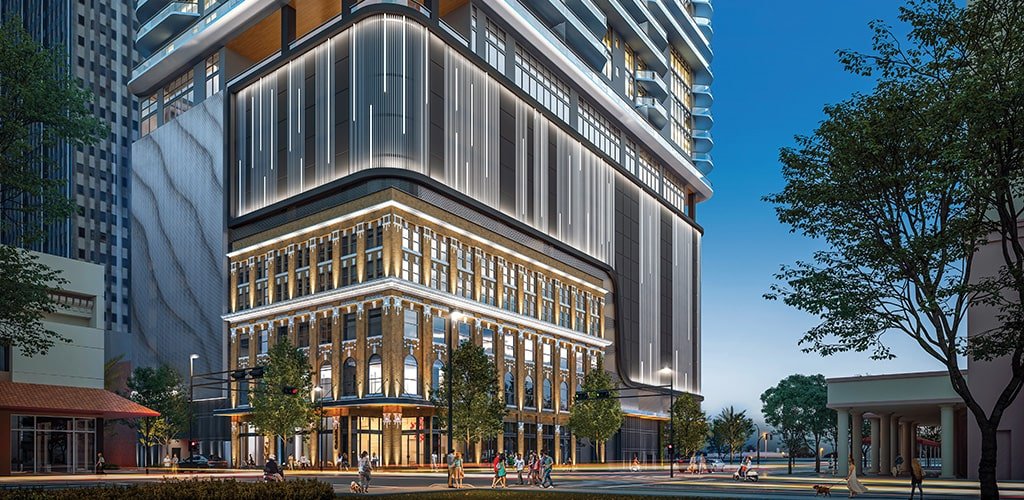 Street-level dusk rendering of ONE Tampa's podium and historic brick base