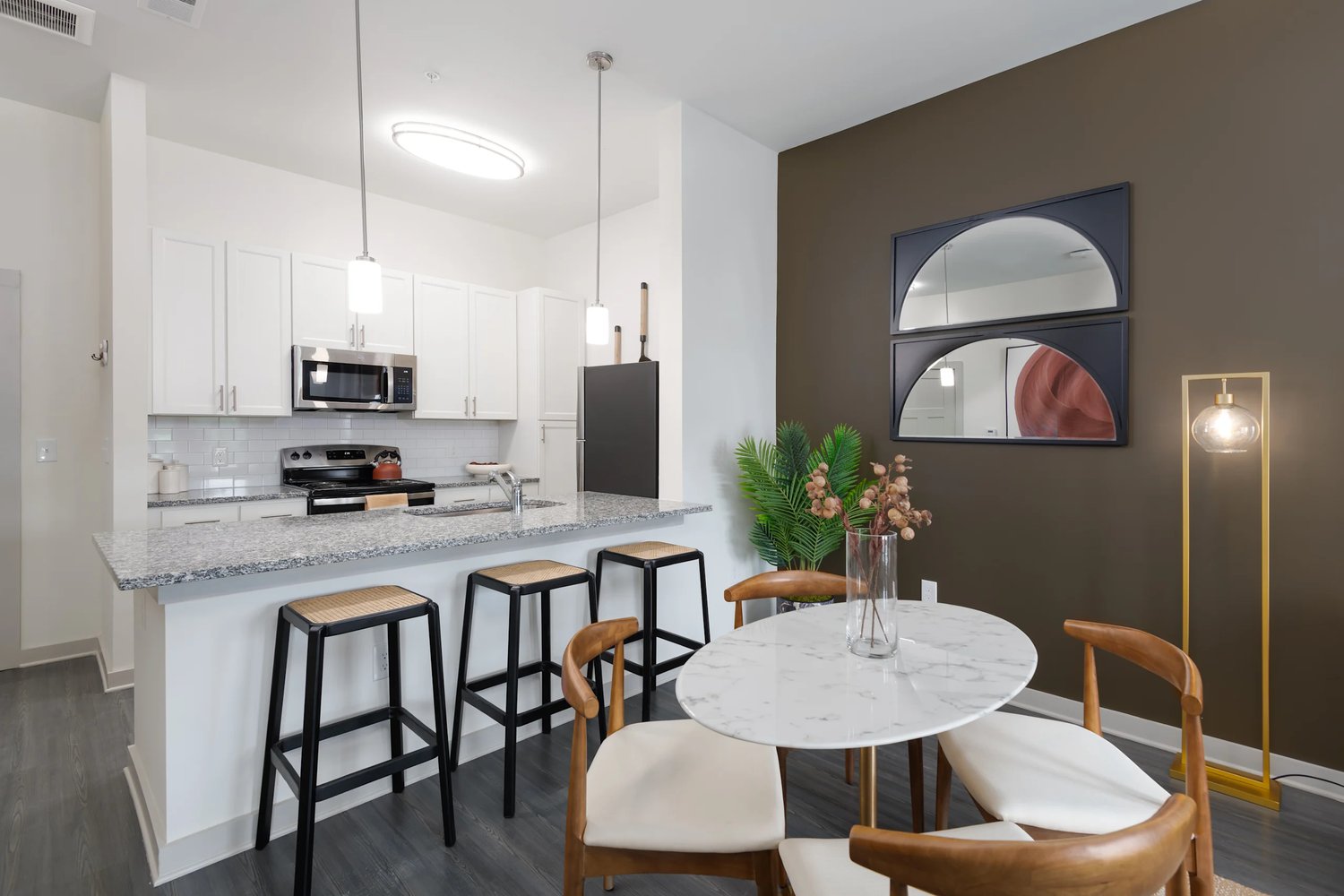 Kitchen and dining area in a residence at The Flats at Laurel & Pine