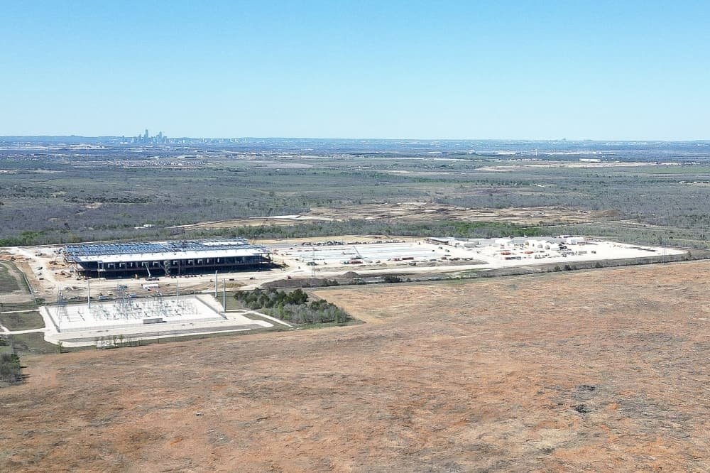 The EdgeConneX Cedar Creek data center site under construction, with the Austin skyline on the horizon